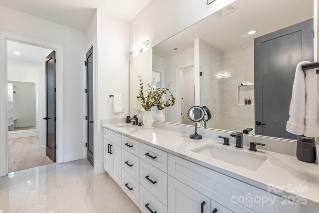 2021 S St, Charlotte, NC 28208 - bathroom with double vanity, a stall shower, marble finish flooring, baseboards, and recessed lighting