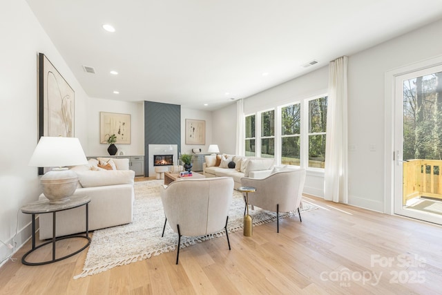 2013 S St, Charlotte, NC 28208 - living room with light wood-style floors, a glass covered fireplace, recessed lighting, and baseboards
