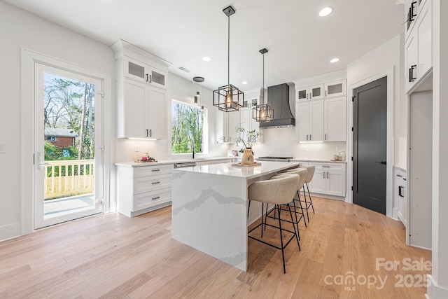 2013 S St, Charlotte, NC 28208 - kitchen featuring custom exhaust hood, healthy amount of natural light, a kitchen island, backsplash, and recessed lighting