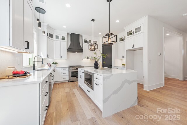 2013 S St, Charlotte, NC 28208 - kitchen featuring custom exhaust hood, a sink, stainless steel appliances, recessed lighting, and a kitchen island