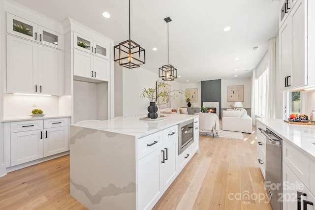 2013 S St, Charlotte, NC 28208 - kitchen with appliances with stainless steel finishes, light wood-type flooring, recessed lighting, white cabinetry, and a center island