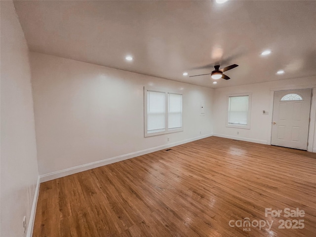 spare room featuring recessed lighting, baseboards, ceiling fan, and light wood finished floors