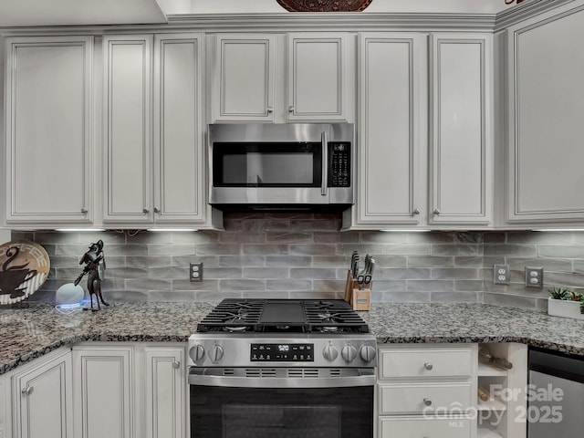 kitchen with backsplash, appliances with stainless steel finishes, and light stone countertops