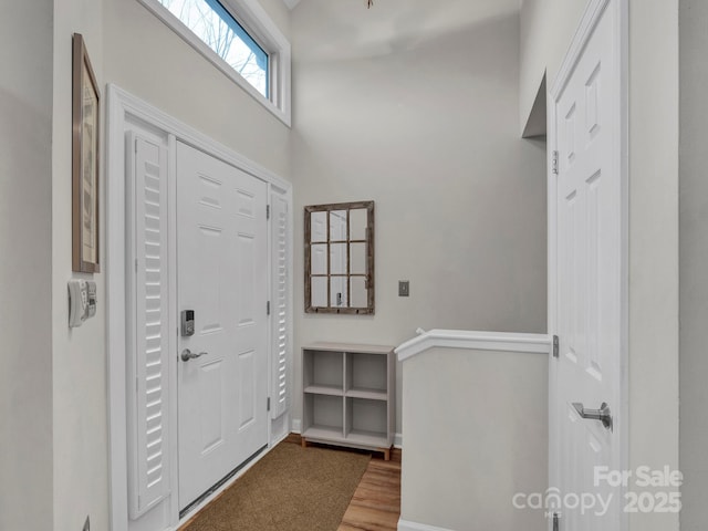 foyer featuring wood finished floors