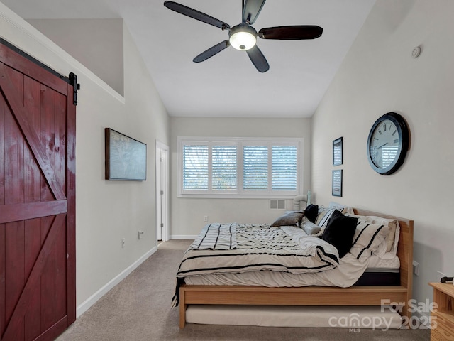 bedroom with visible vents, baseboards, lofted ceiling, a barn door, and light colored carpet