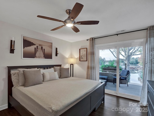 bedroom with access to exterior, visible vents, ceiling fan, and dark wood-style flooring