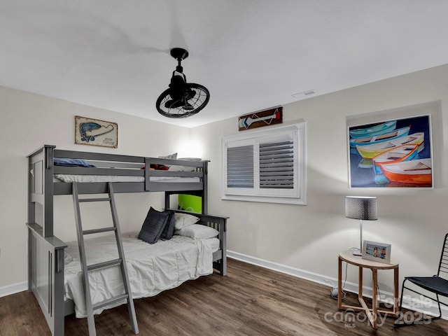 bedroom featuring visible vents, baseboards, and wood finished floors