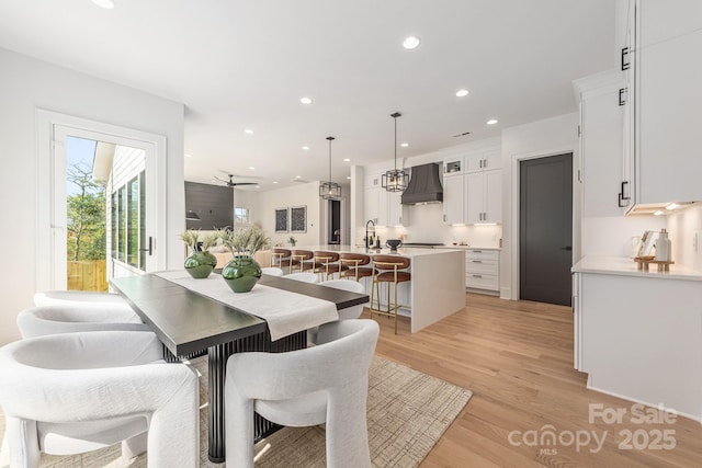 dining area featuring recessed lighting and light wood-style flooring