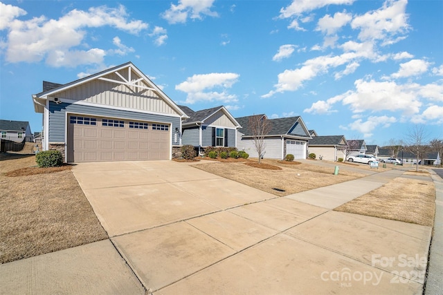 view of front facade featuring stone siding, board and batten siding, concrete driveway, and a garage