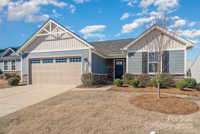 craftsman-style house featuring stone siding, board and batten siding, concrete driveway, and an attached garage