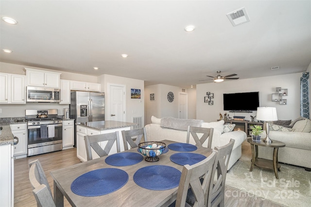 dining space with a ceiling fan, recessed lighting, light wood-style floors, and visible vents