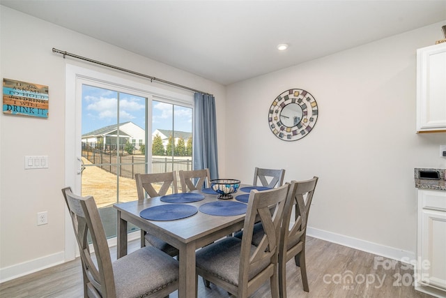 dining room with recessed lighting, light wood-style floors, and baseboards