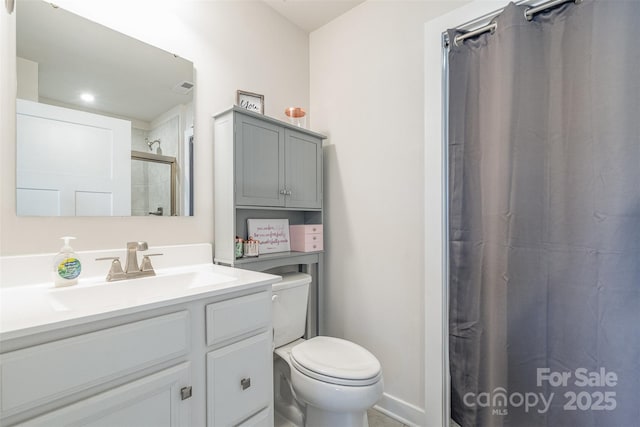 bathroom with curtained shower, toilet, vanity, and visible vents