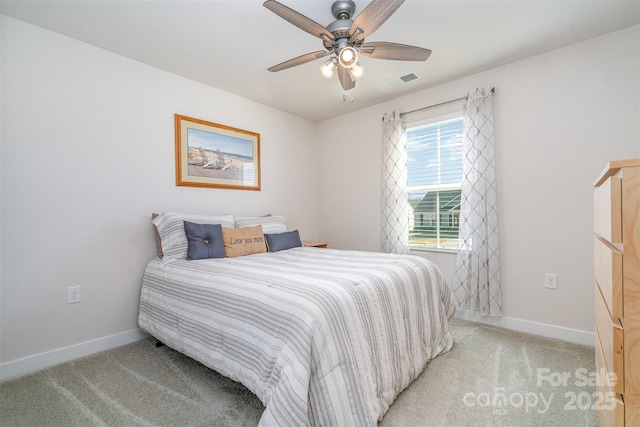 bedroom featuring ceiling fan, light colored carpet, visible vents, and baseboards