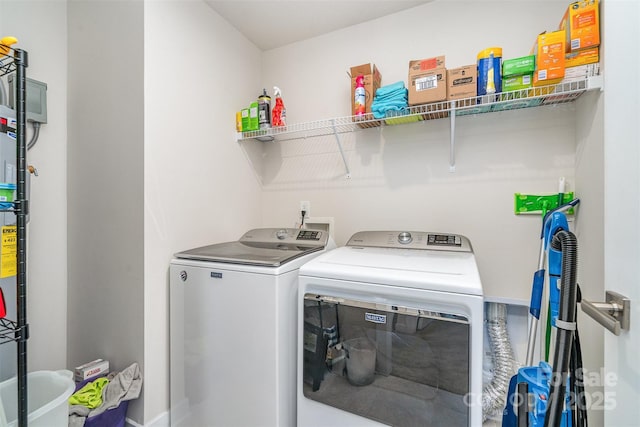 clothes washing area featuring washing machine and clothes dryer and laundry area