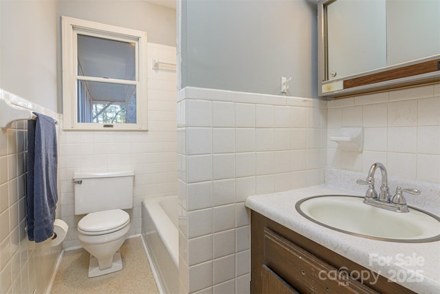 full bath with toilet, a tub, tile walls, speckled floor, and vanity