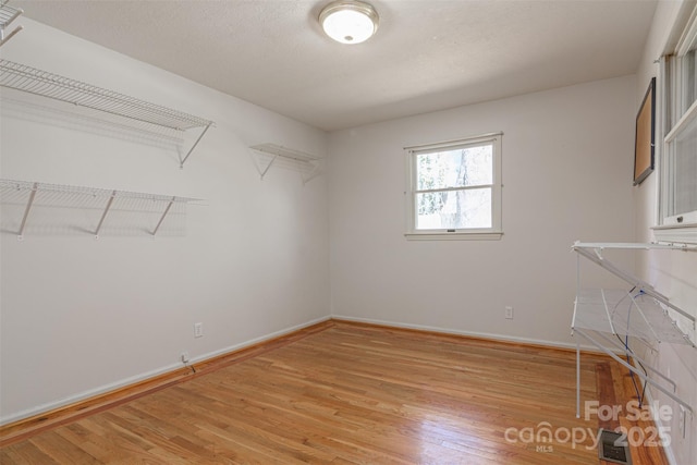 spacious closet featuring light wood-type flooring