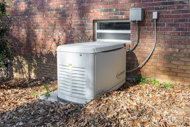 exterior details featuring brick siding and a power unit