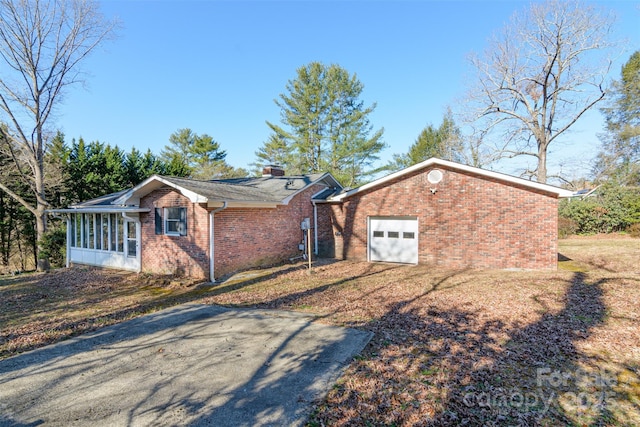 view of front facade featuring brick siding and a sunroom