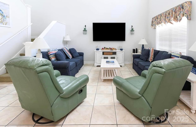 living room with light tile patterned floors and baseboards