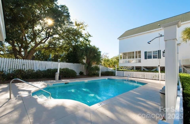 pool featuring a patio and a fenced backyard