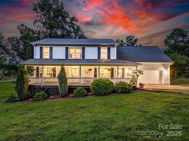 farmhouse-style home featuring a front lawn, a garage, covered porch, and concrete driveway