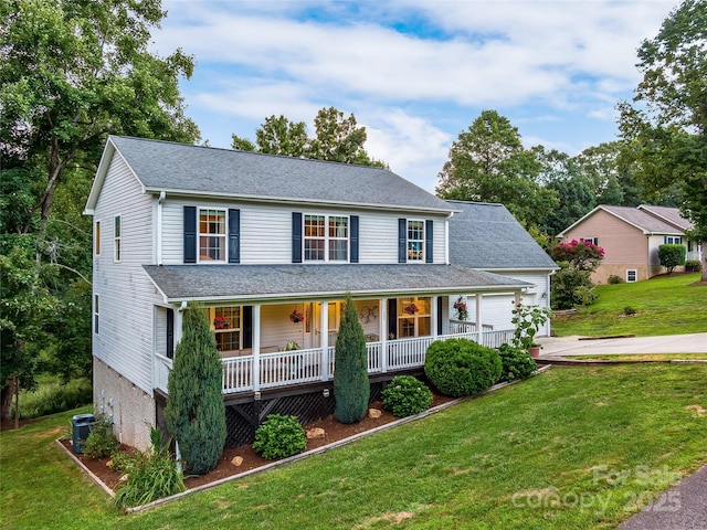 view of front of house with a porch, cooling unit, a front yard, and driveway