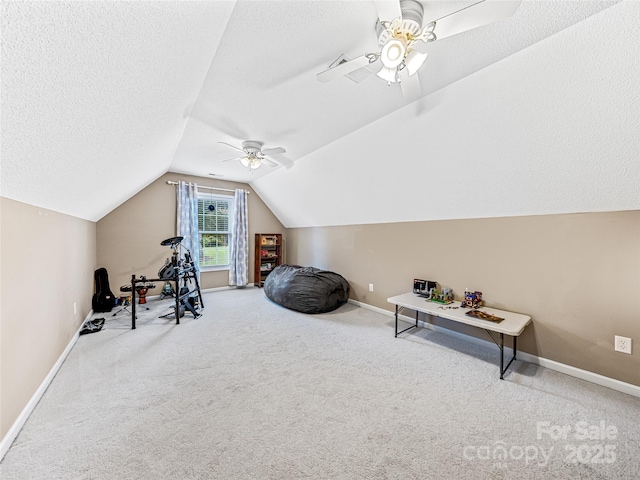 exercise room featuring baseboards, lofted ceiling, ceiling fan, a textured ceiling, and carpet flooring