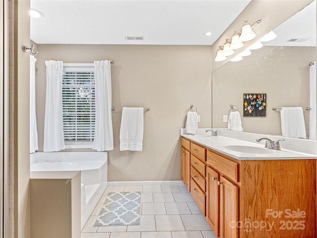 full bath with tile patterned flooring, visible vents, double vanity, and a sink