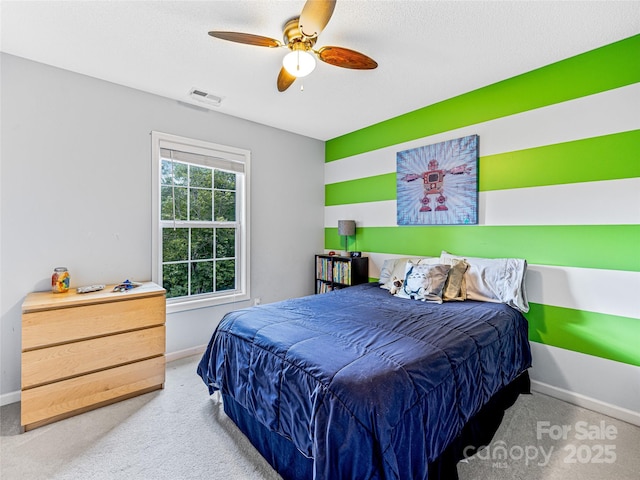 bedroom featuring carpet flooring, baseboards, visible vents, and ceiling fan