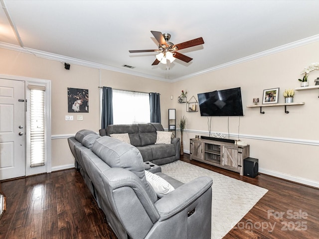 living area featuring visible vents, ornamental molding, a ceiling fan, wood finished floors, and baseboards