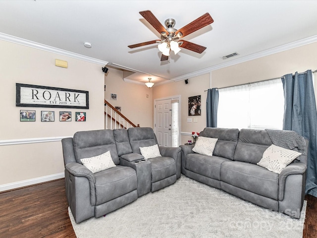 living room featuring visible vents, crown molding, baseboards, ceiling fan, and wood finished floors