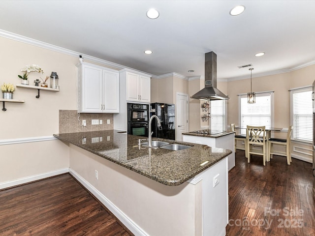 kitchen with black appliances, a sink, a peninsula, island range hood, and crown molding