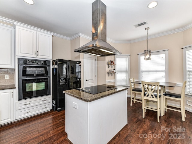 kitchen with black appliances, island exhaust hood, visible vents, and ornamental molding