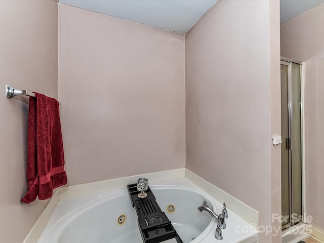 full bathroom with a whirlpool tub and a shower stall