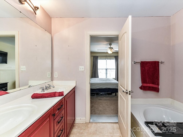 bathroom featuring a sink, connected bathroom, a garden tub, and double vanity