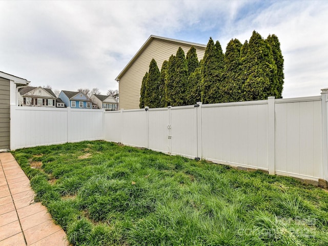 view of yard with a fenced backyard