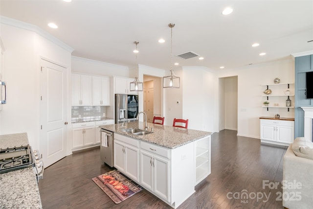 kitchen featuring white cabinetry, dark wood-style flooring, appliances with stainless steel finishes, and a sink