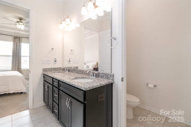 bathroom featuring a sink, double vanity, ensuite bath, and tile patterned floors