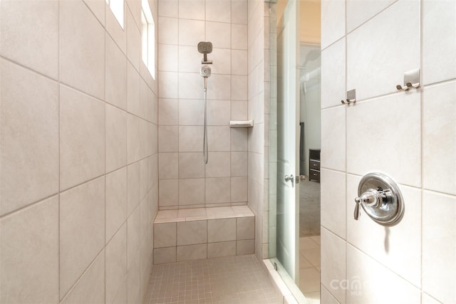 bathroom with a tile shower