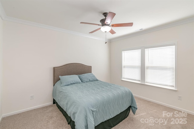 carpeted bedroom featuring visible vents, baseboards, ceiling fan, and crown molding