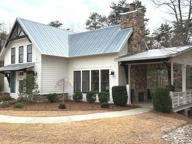 19011 Dry Narrows Way, Charlotte, NC 28278 - view of property exterior with a chimney and metal roof