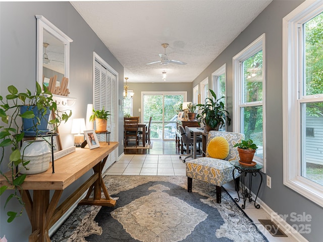 sunroom with visible vents and ceiling fan