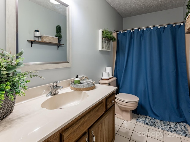 bathroom featuring curtained shower, toilet, vanity, tile patterned floors, and a textured ceiling