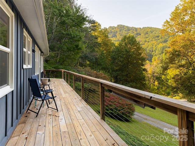 wooden deck with a wooded view