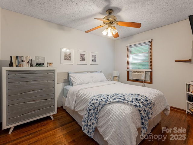 bedroom with cooling unit, a ceiling fan, baseboards, wood-type flooring, and a textured ceiling