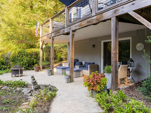 view of patio with an outdoor living space with a fire pit