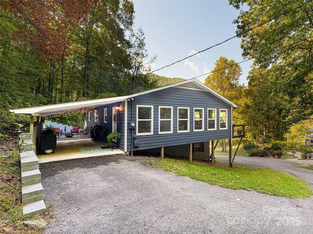 view of front facade with aphalt driveway and an attached carport