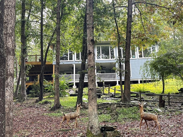 rear view of house featuring ceiling fan