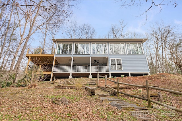 view of front facade with a ceiling fan and a wooden deck